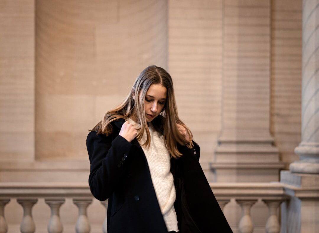 woman wearing silk blouse and wool coat