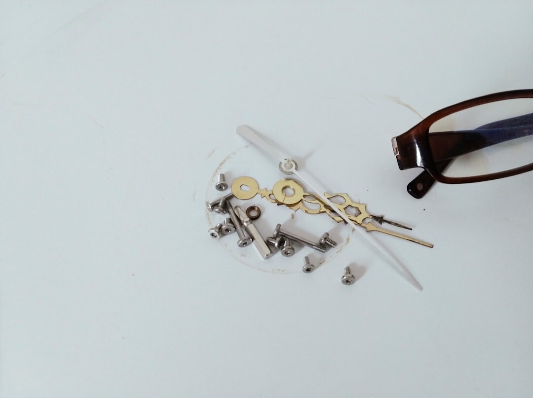 Swiss watchmaker hands assembling a movement with tools